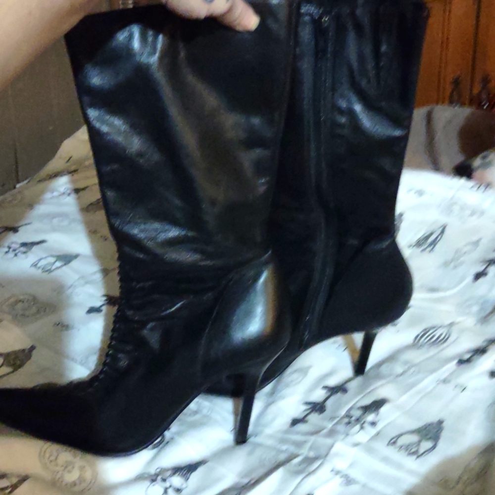Tease black leather high heeled boots.